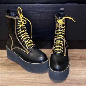 Lace up platform combat boots with yellow stitch